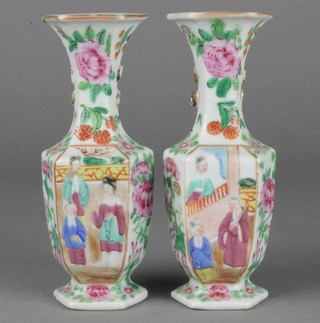 A pair of famille rose hexagonal oviform vases with panels of figures in pavilions on a ground of flowers 5 1/2" 
