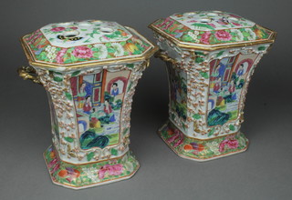 A good pair of 19th Century Cantonese octagonal tapered vases with pierced lids, decorated with insects amongst flowers and panels of figures in pavilion gardens, having rope twist handles, 8 1/2" 