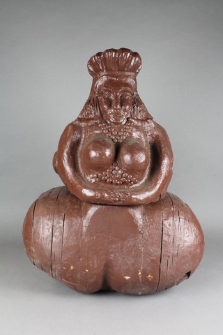 A carved brown painted rustic wooden figure raised on a barrel shaped base 22"h x 19"w and 10"d, the base marked E Walker 
