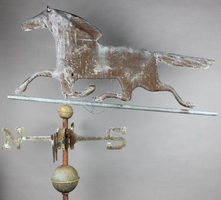 A 19th Century copper weather vane in the form of a running horse 13"h x 31"l, raised on an iron and metal pole 39" x 18 1/2"l 