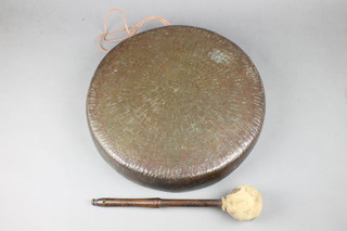 A circular bronze gong complete with beater 16" 