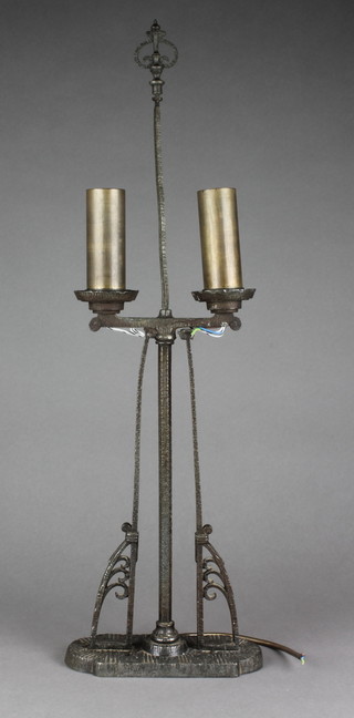 An Art Nouveau "Bauhaus" wrought metal twin light table lamp in the form of a twin light candelabrum, raised on an oval base 25"h 