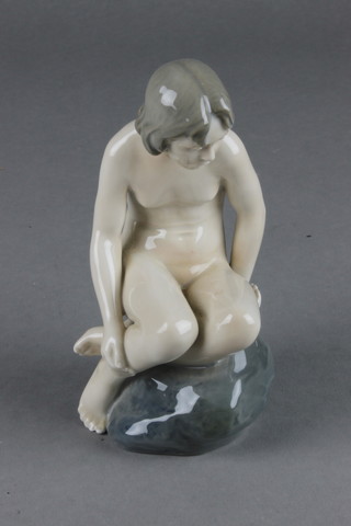A Royal Copenhagen figure of a young girl sitting on a rock no. 4027 5 1/2" 