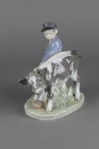 A Royal Copenhagen figure of a youth with calf no.772 6 1/2" 