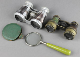 A pair of aluminium and mother of pearl opera glasses, a pair of gilt metal leather bound opera glasses and a magnifying glass
