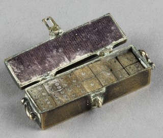 A set of 26  miniature brass dominoes contained in a rectangular brass twin handled casket with hinged lid