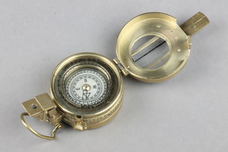 A reproduction brass military issue prismatic compass