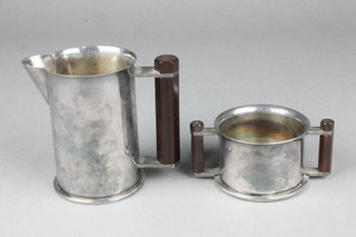 A Trench Art silver plated cream jug and sugar bowl formed from a pair of 1938 6lb shell cases 