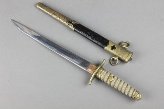 A World War Two Japanese Naval Officer's dirk with 8 1/2" blade, shagreen grip, contained in a leather scabbard 
