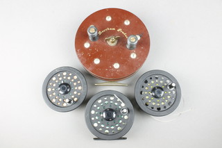 A Shakespeare graflite 2755 centrepin fishing reel 3 1/2" and 2 spare spools and lines, a Lewtham 6" centre pin fishing reel 