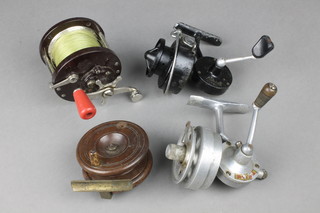 A 19th Century brass mahogany star back centrepin fishing reel 3", (handle damaged and missing 1 handle) a Mitchell Gap fishing reel, a Penn no.85 reel and 1 other reel 