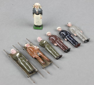 A lead figure of a nursing sister together with 2 stretchers and 6 casualties 