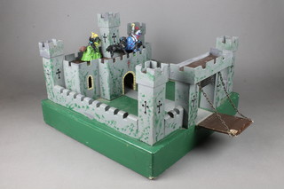 A wooden model of a fort complete with drawbridge and figures of knights 10"h x 18"w x 18"d 