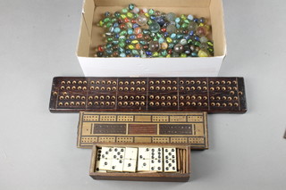 2 cribbage boards, a set of dominoes and various marbles 