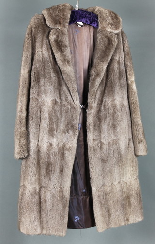 A lady's grey tinted half length fur coat