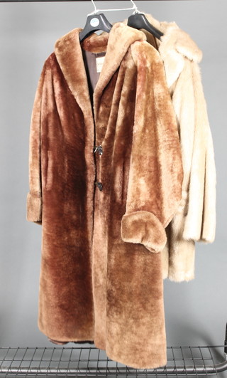 Dickens & Jones, a lady's full length orange tinted simulated fur coat and a lady's half length simulated fur coat 