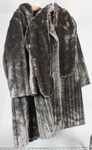 Dyna Mink, a lady's black simulated fur full length coat together with a ditto stole, 1 other black full length coat by H F Greenfield 