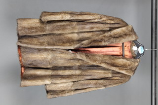 A lady's quarter length brown fur coat