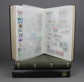 A black stock book of various used GB stamps, a Stanley Gibbons International stamp album of world stamps, loose leaf album of GB presentation stamps and first day covers
