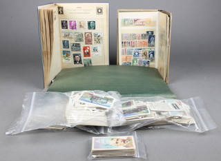 A stock book of various world stamps, a small blue stamp album, a green stamp  album, 6 tuppeny blues and a small collection of tea cards 