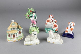 A 19th Century Staffordshire figure of a gentleman with hounds standing before a  tree 6", 2 spaniel groups, 2 reclining sheep and a cottage 
