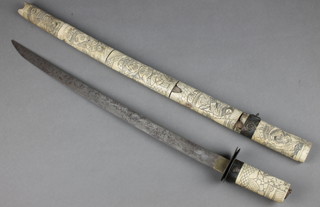 A Wakizashi sword with 19 1/2" blade contained in a carved bone scabbard 