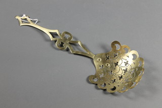 A Victorian pierced brass cream skimmer