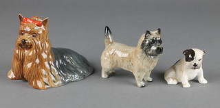 A Beswick figure of a Yorkshire Terrier 1944 4 1/2", a ditto Westmorland Terrier 3 3/4" and a Royal Doulton seated bulldog puppy 2" 