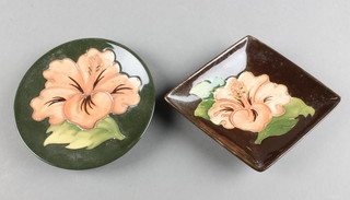 A Moorcroft brown ground diamond shaped dish decorated with a flower 4", a circular green ground ditto 4" 