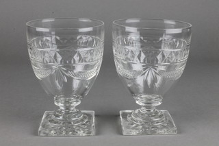 A pair of 19th Century cut glass wines with swag and crest decoration 5 1/2" 