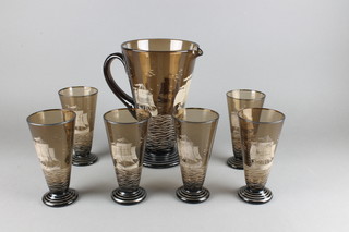 An amber glass lemonade set decorated with a galleon comprising a tapered jug 11" and 6 tapered glasses 6 1/2" 