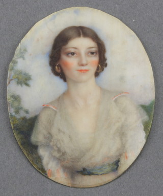 20th Century watercolour, an oval portrait miniature study of a young lady in a garden setting, unframed 2 1/2" x 2" 