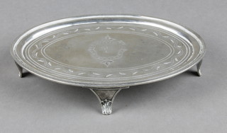 An oval George III silver teapot stand with monogrammed cartouche amongst scrolling flowers on scroll feet, London 1798 136 grams 