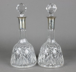 A pair of mallet shaped decanters and stoppers with silver collars 12" 