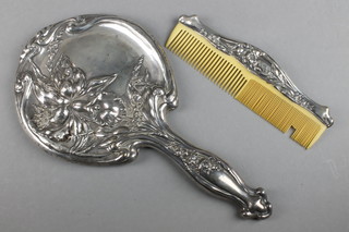 An Art Nouveau repousse silver hand mirror and comb decorated with irises Chester 1910 