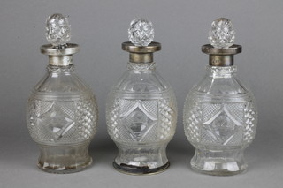 3 cut glass bulbous spirit decanters and stoppers with silver mounts  