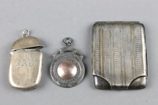 An engine turned silver match sleeve, a ditto vesta and sports fob, 44 grams