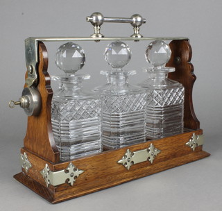 An Edwardian silver plated mounted 3 bottle tantalus 