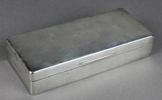 A silver rectangular cigarette box with engraved monogram, London 1935 