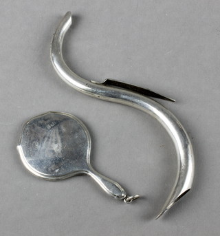 An Edwardian silver miniature hand mirror 2", a scroll shaped whistle 