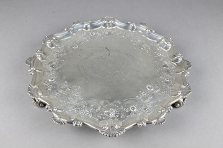 A George III silver salver with Chippendale and shell rim on scroll feet with later repousse decoration and engraved inscription, London 1760, 880 grams 