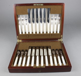 An Edwardian mahogany canteen containing a set of 12 silver plated dessert eaters with mother of pearl handles 