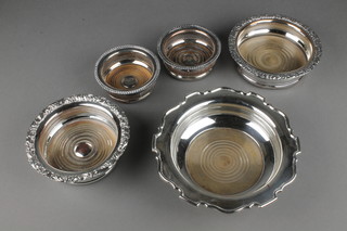 A pair of silver plated pierced coasters with gadroon rims 4" and 3 other coasters