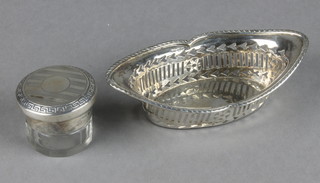 An oval pierced silver dish Birmingham 1902, 34 grams, a silver mounted toilet jar London 1926