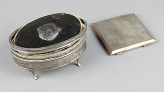 An oval silver trinket box with later lid and an engine turned compact 