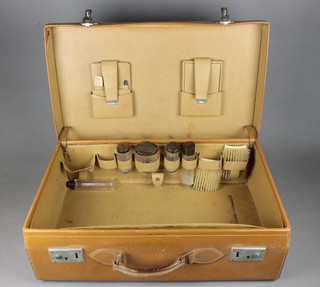 A leather toilet case containing 5 silver mounted accessories