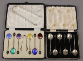 A pair of Georgian silver sugar nips and 2 cased sets