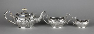 A silver plated fluted tea set with scroll handles