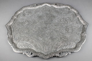 A Persian silver plated chased and engraved quatrefoil tray decorated with scrolling foliage and feathers 24" 