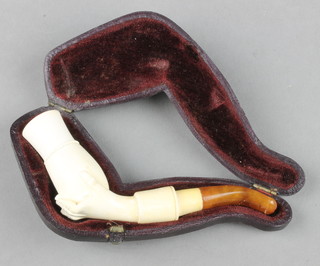 A cased Meerschaum pipe, the bowl in the form of a hand holding a vase in a fitted case 